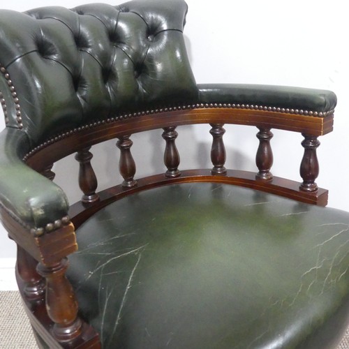 659 - A 20th century green leather Captains swivel Desk Chair, raised on castors, W 64 cm x H 83 cm x D 60... 