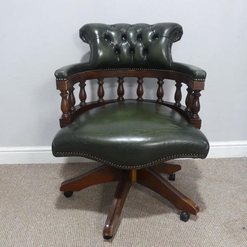 659 - A 20th century green leather Captains swivel Desk Chair, raised on castors, W 64 cm x H 83 cm x D 60... 