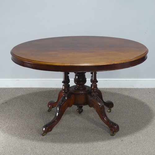 690 - A late 19th century mahogany tilt-top Table, the top of oval form, raised on birdcage and column upo... 