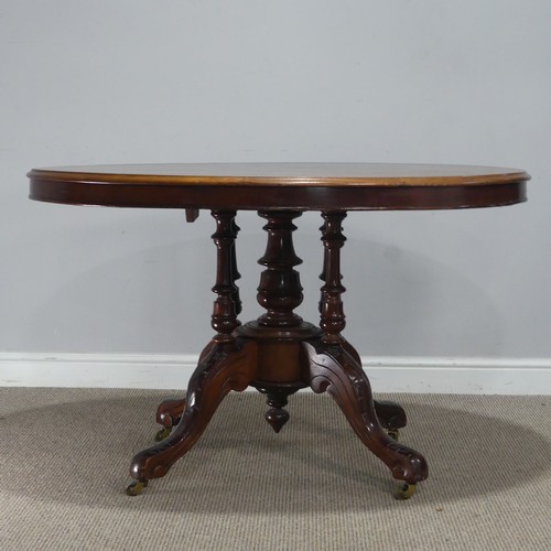 690 - A late 19th century mahogany tilt-top Table, the top of oval form, raised on birdcage and column upo... 