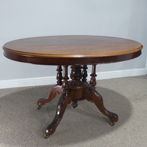 690 - A late 19th century mahogany tilt-top Table, the top of oval form, raised on birdcage and column upo... 