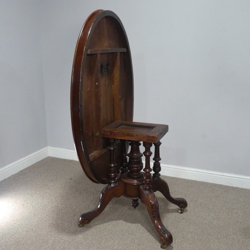 690 - A late 19th century mahogany tilt-top Table, the top of oval form, raised on birdcage and column upo... 