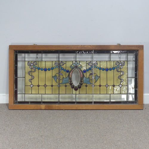 701 - An early 20th century stained glass Panel, mounted in wooden frame, W 136.5 cm x H 65 cm.... 