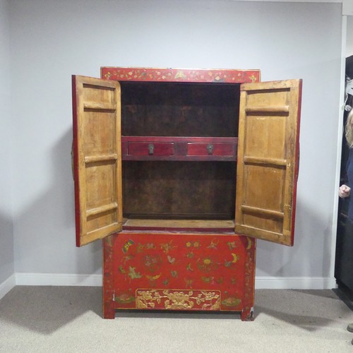 702 - An antique Chinese red-lacquered Cabinet, with two cupboard doors and hinged top compartment, decora... 