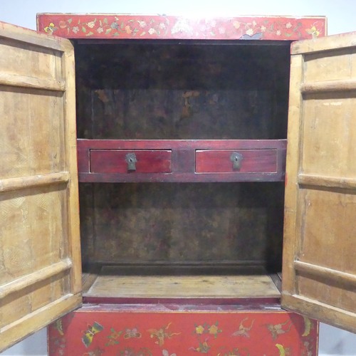 702 - An antique Chinese red-lacquered Cabinet, with two cupboard doors and hinged top compartment, decora... 