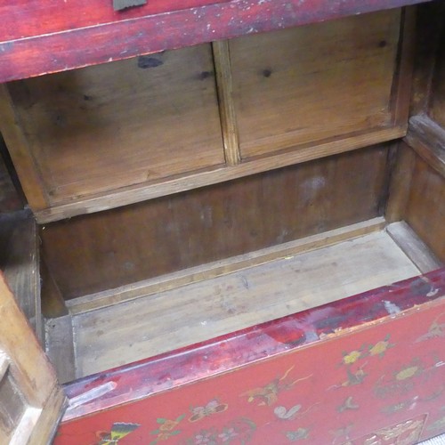 702 - An antique Chinese red-lacquered Cabinet, with two cupboard doors and hinged top compartment, decora... 