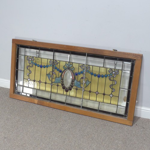 701 - An early 20th century stained glass Panel, mounted in wooden frame, W 136.5 cm x H 65 cm.... 