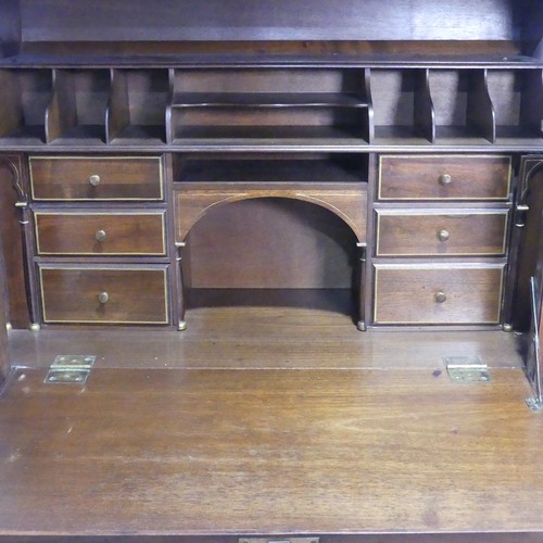 698 - An early 20th century leather and walnut domed-top Bureau, in a Renaissance Revival style, raised on... 