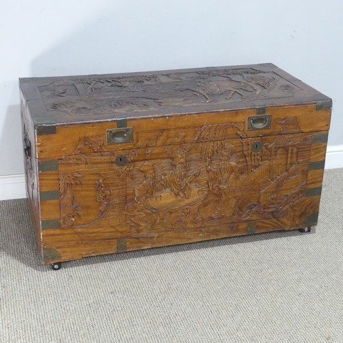 694 - A Chinese carved metal bound camphorwood Chest, with gilt metal inset handles, W 104 cm x H 54.5 cm ... 