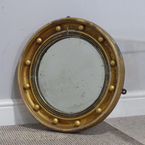 714 - A 19th century Regency style gilt circular wall Mirror, the frame decorated with applied gilt sphere... 