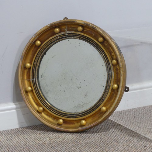 714 - A 19th century Regency style gilt circular wall Mirror, the frame decorated with applied gilt sphere... 