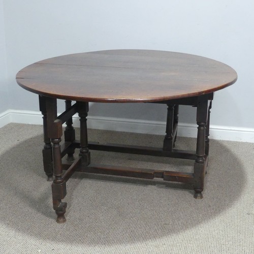 717 - An antique oak gateleg Table, raised on turned supports, W 124 cm x H 69 cm x D 148 cm.... 