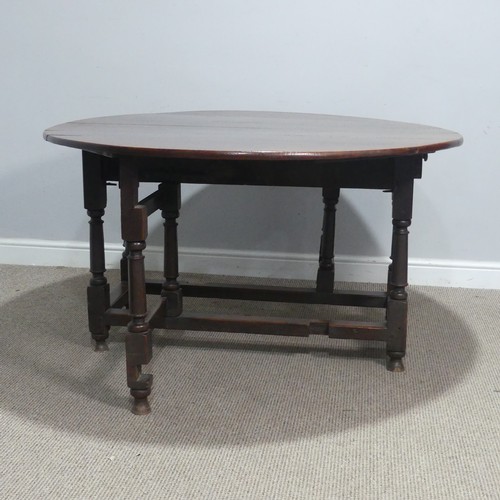 717 - An antique oak gateleg Table, raised on turned supports, W 124 cm x H 69 cm x D 148 cm.... 