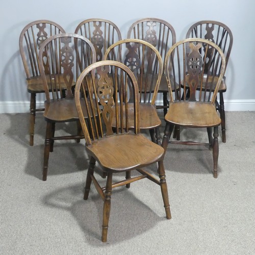 718 - A 19th century harlequin set of eight wheelback dining Chairs, with shaped saddle seats raised on tu... 