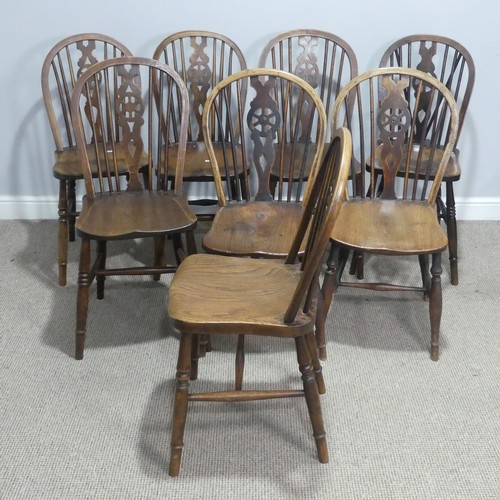 718 - A 19th century harlequin set of eight wheelback dining Chairs, with shaped saddle seats raised on tu... 