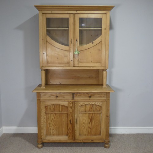 748 - A 20th century pine kitchen Dresser, the moulded cornice over glazed doors and shelves, raised on cu... 