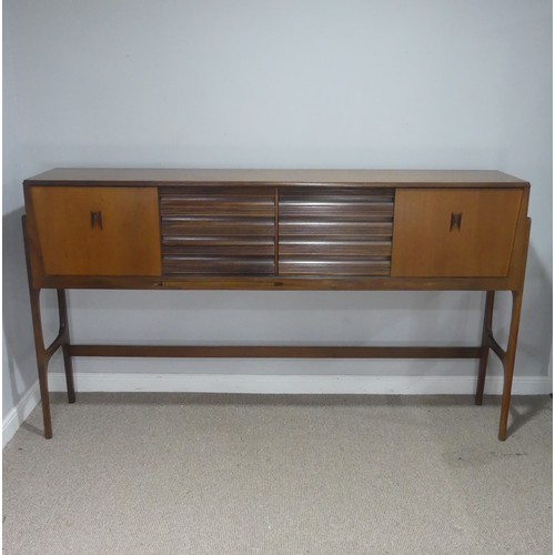 733 - A mid-20th century teak Elliots of Newbury sideboard dining room Set, the sideboard with retracting ... 