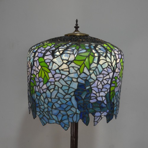 738 - A Tiffany & Co style standard Lamp, the stained and lead lined glass shade raised on metal colum... 