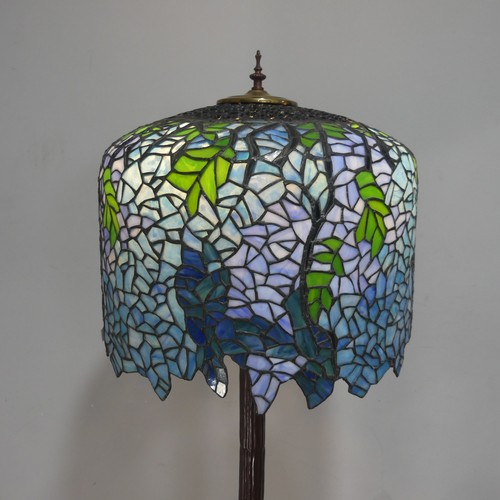 738 - A Tiffany & Co style standard Lamp, the stained and lead lined glass shade raised on metal colum... 