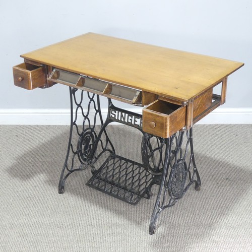 736 - An early 20th century Singer sewing Table, converted to writing table with later wooden top, W 91 cm... 