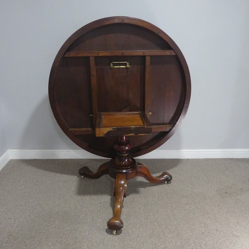 565 - A 19th century mahogany circular breakfast Table, raised on a turned column and three scrolled suppo... 