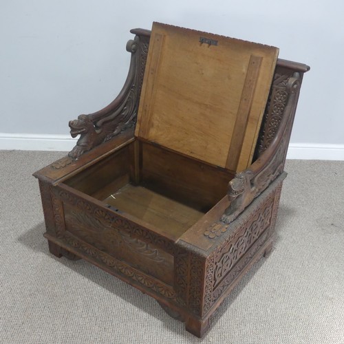 745 - A Victorian carved oak box Seat/Settle, decorated with scrolled pierced foliage and with carved drag... 