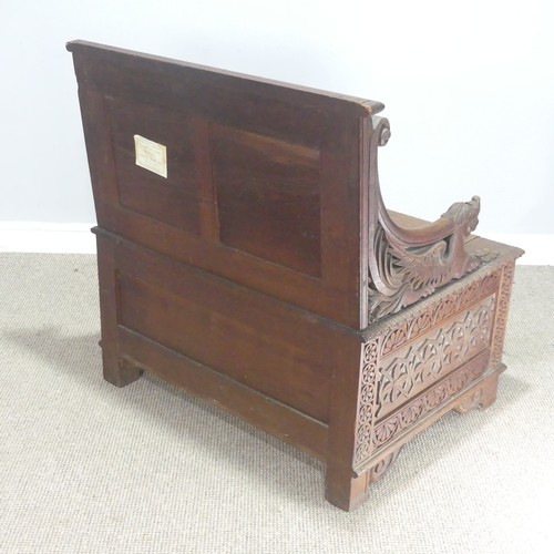 745 - A Victorian carved oak box Seat/Settle, decorated with scrolled pierced foliage and with carved drag... 