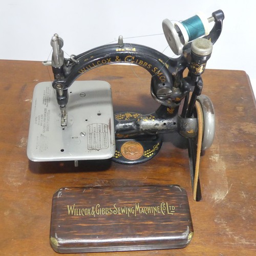 An antique Willcox & Gibbs treadle Sewing Machine, with original