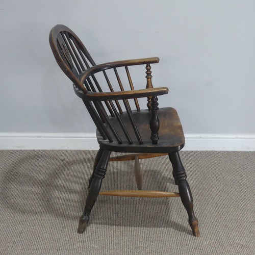 742 - An antique ash and elm Windsor Armchair, with shaped saddle seat raised on turned supports united by... 