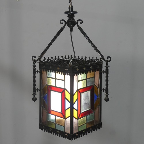 753 - An Arts and Crafts stained glass Lantern, the four panels of lead lined glass mounted in a gothic st... 