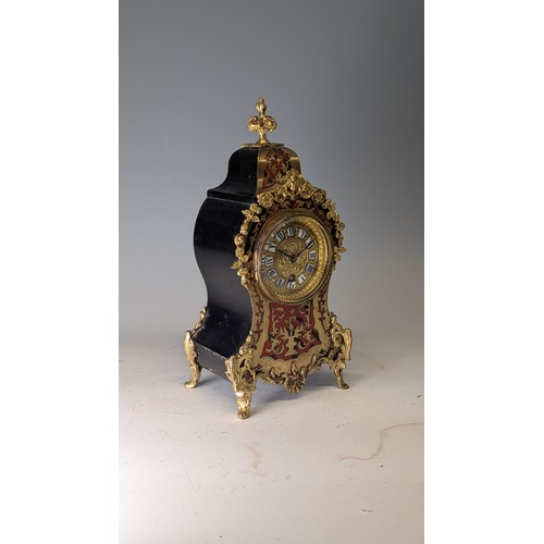 711 - A late 19th century French brass mounted and red tortoiseshell Boulle mantel Clock, the brass-cast d... 