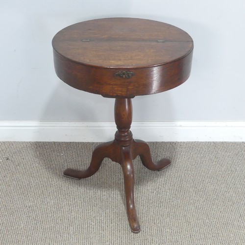 759 - An early 20th century oak drum tripod Table, the hinged circular top raised on turned column, upon c... 