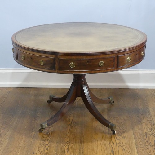 598 - A Regency mahogany revolving drum Table, of small proportions, the circular top inset with green gil... 