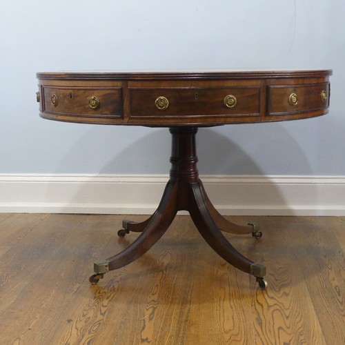 598 - A Regency mahogany revolving drum Table, of small proportions, the circular top inset with green gil... 