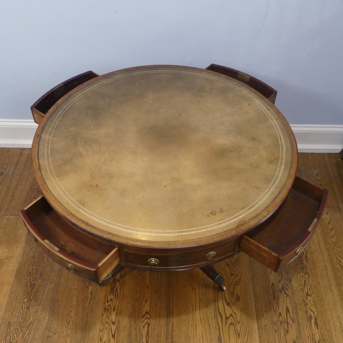 598 - A Regency mahogany revolving drum Table, of small proportions, the circular top inset with green gil... 