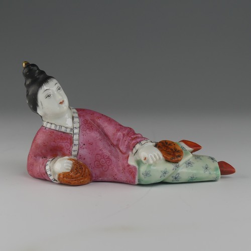 104 - An early 20thC Chinese famille rose porcelain Snuff Bottle, in the form of a recumbent woman with a ... 