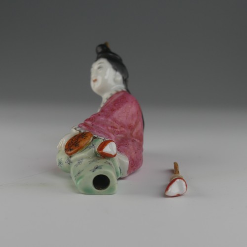 104 - An early 20thC Chinese famille rose porcelain Snuff Bottle, in the form of a recumbent woman with a ... 