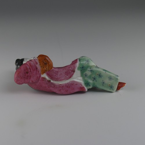 104 - An early 20thC Chinese famille rose porcelain Snuff Bottle, in the form of a recumbent woman with a ... 