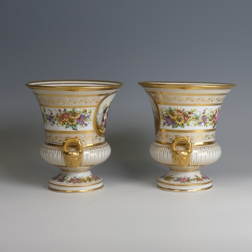 40 - A pair of late 19thC French porcelain Urns, decorated with gilded bands of vines, with central depic... 