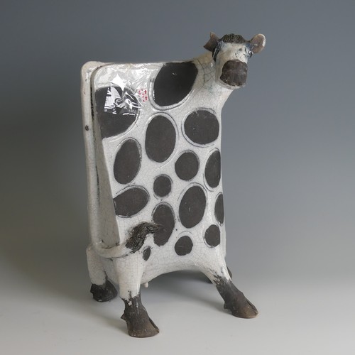 53 - Lawson Rudge (b. 1936) a studio pottery raku Cow, stylised form, decorated with wax resist spots to ... 