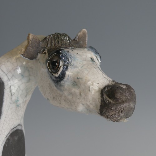 53 - Lawson Rudge (b. 1936) a studio pottery raku Cow, stylised form, decorated with wax resist spots to ... 