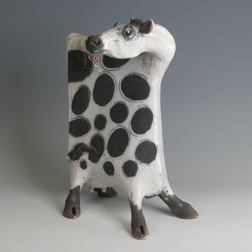 53 - Lawson Rudge (b. 1936) a studio pottery raku Cow, stylised form, decorated with wax resist spots to ... 