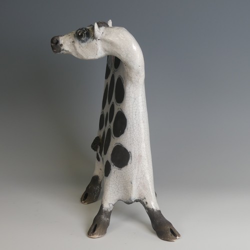 53 - Lawson Rudge (b. 1936) a studio pottery raku Cow, stylised form, decorated with wax resist spots to ... 