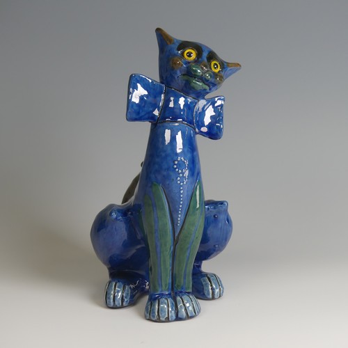 56 - A C. H. Brannam pottery figure of a Cat, with wide grin, sporting a butterfly collar, blue ground pa... 