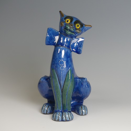 56 - A C. H. Brannam pottery figure of a Cat, with wide grin, sporting a butterfly collar, blue ground pa... 