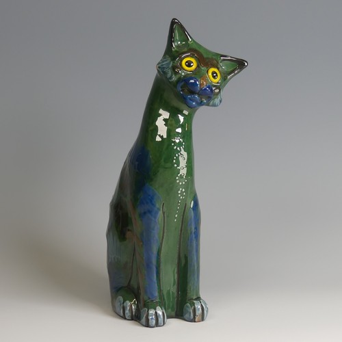 57 - A C. H. Brannam pottery figure of a seated Cat, modelled with cocked head, green ground with blue an... 