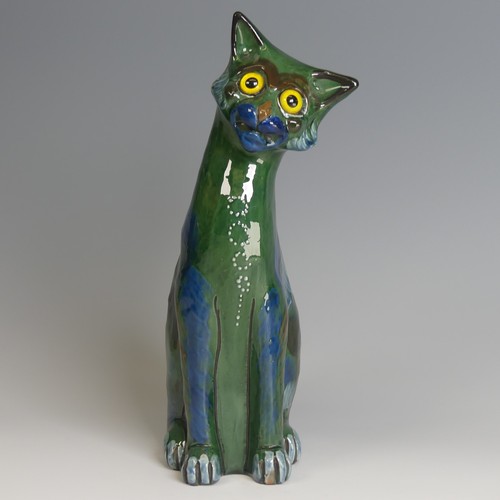 57 - A C. H. Brannam pottery figure of a seated Cat, modelled with cocked head, green ground with blue an... 