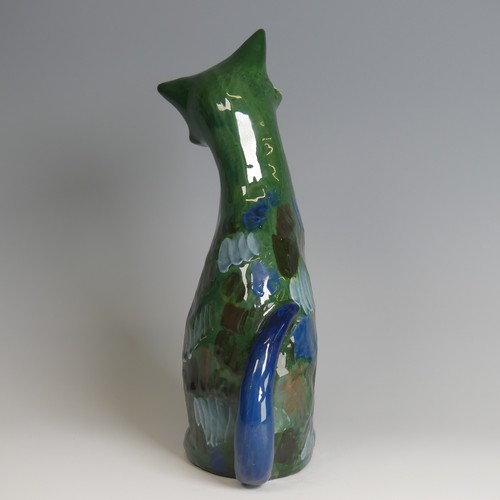 57 - A C. H. Brannam pottery figure of a seated Cat, modelled with cocked head, green ground with blue an... 