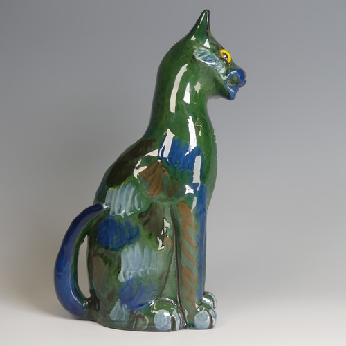 57 - A C. H. Brannam pottery figure of a seated Cat, modelled with cocked head, green ground with blue an... 