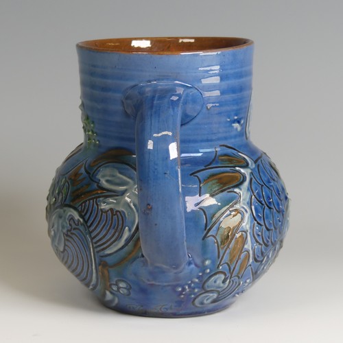 59 - A C. H. Brannam pottery fish Jug, with fish mouth as a spout, decorated to blue ground with floral m... 